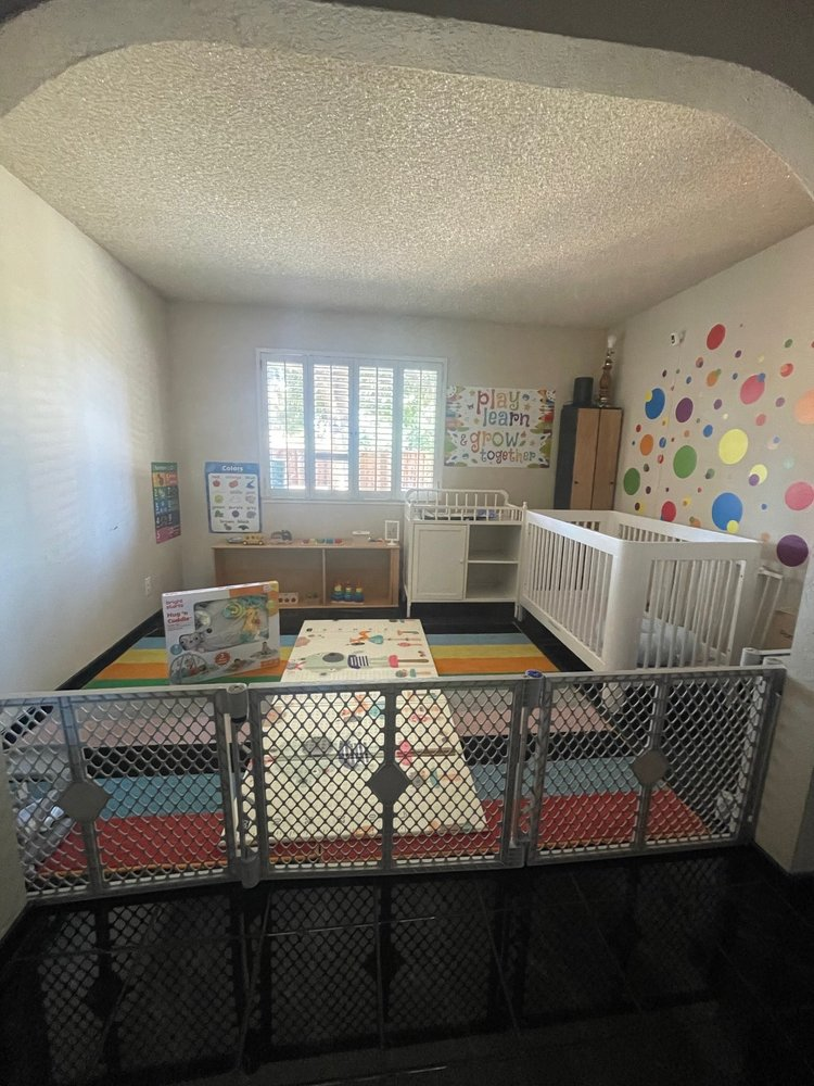 Infant and toddler play area with cribs