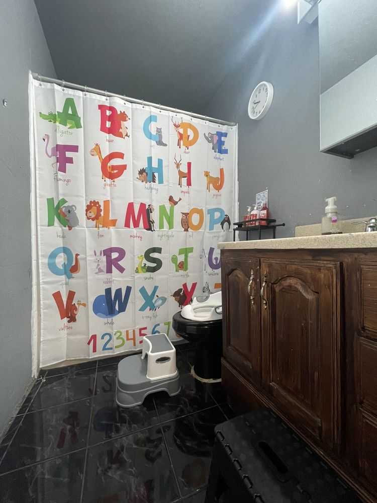 Kid-friendly bathroom with alphabet curtain